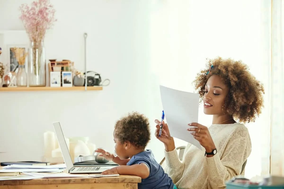 Working mom with small child in her lap