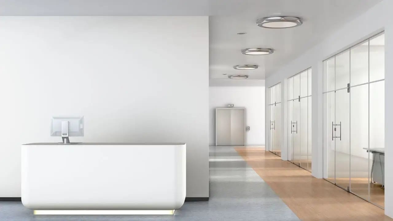 An unattended reception desk inside an office lobby